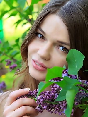 With her youthful beauty and innocent looks, Nedda A portrays a beautiful garden nymph spending a relaxing day with the flowers and lush green grass a